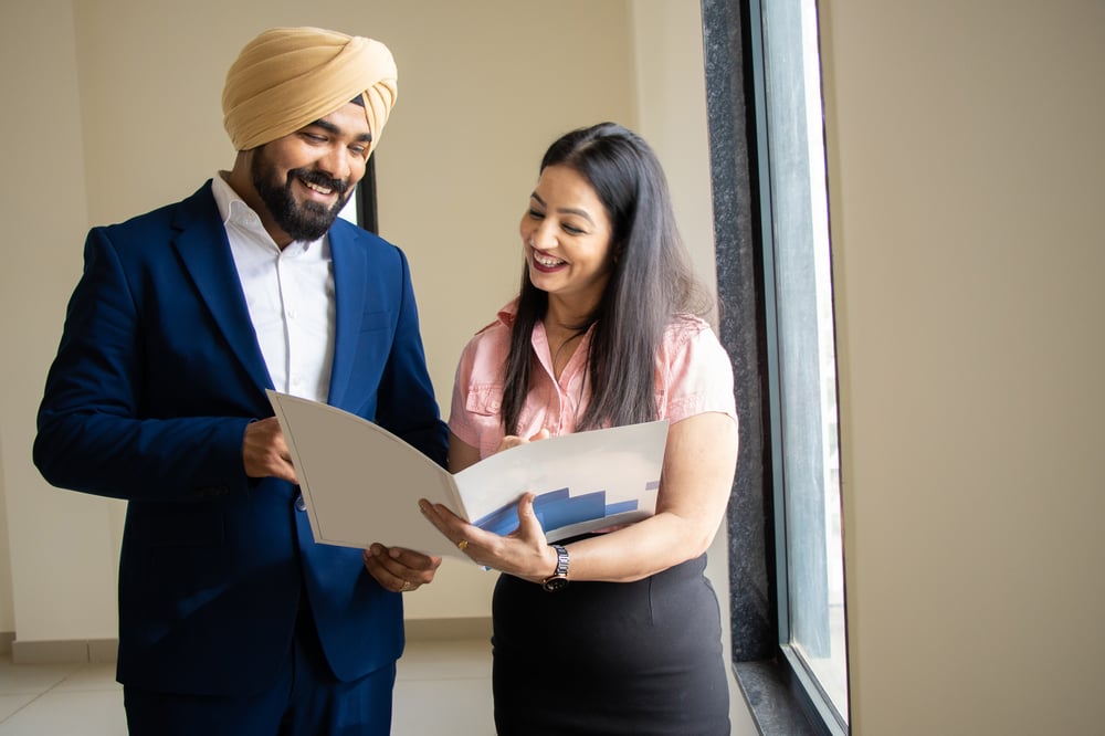 Young businessman with secretary in corporate office